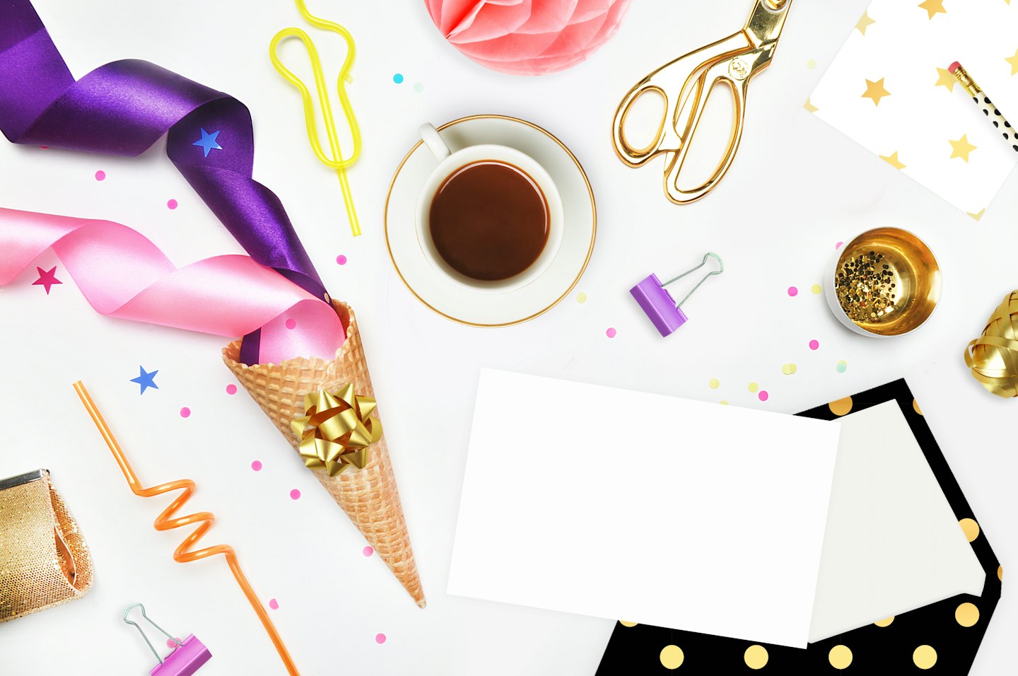 Party supplies and stationery laid out on a white surface.